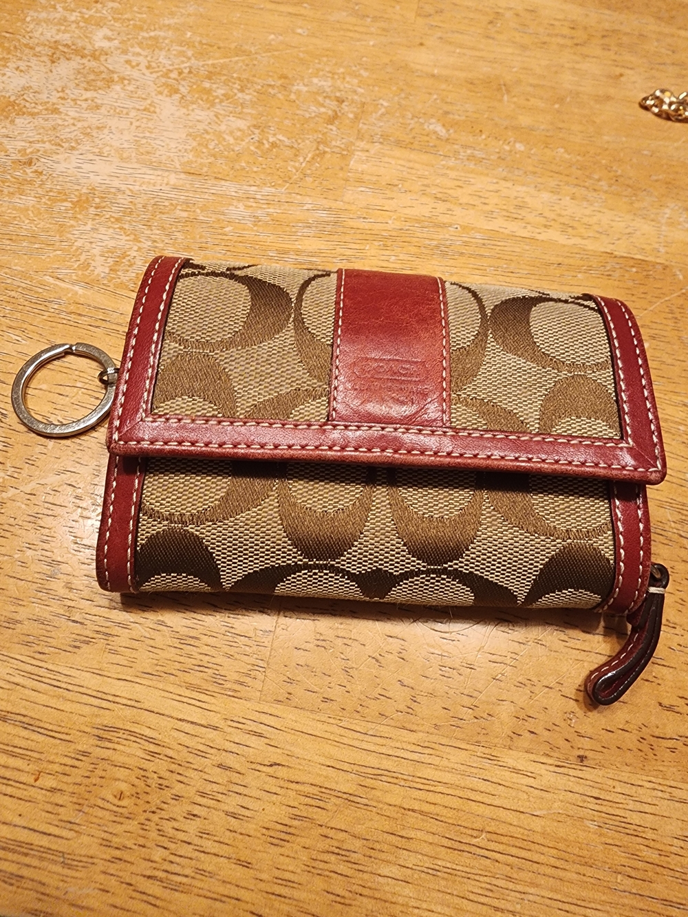 vintage Coach monogram compact wallet featuring brown canvas with red leather